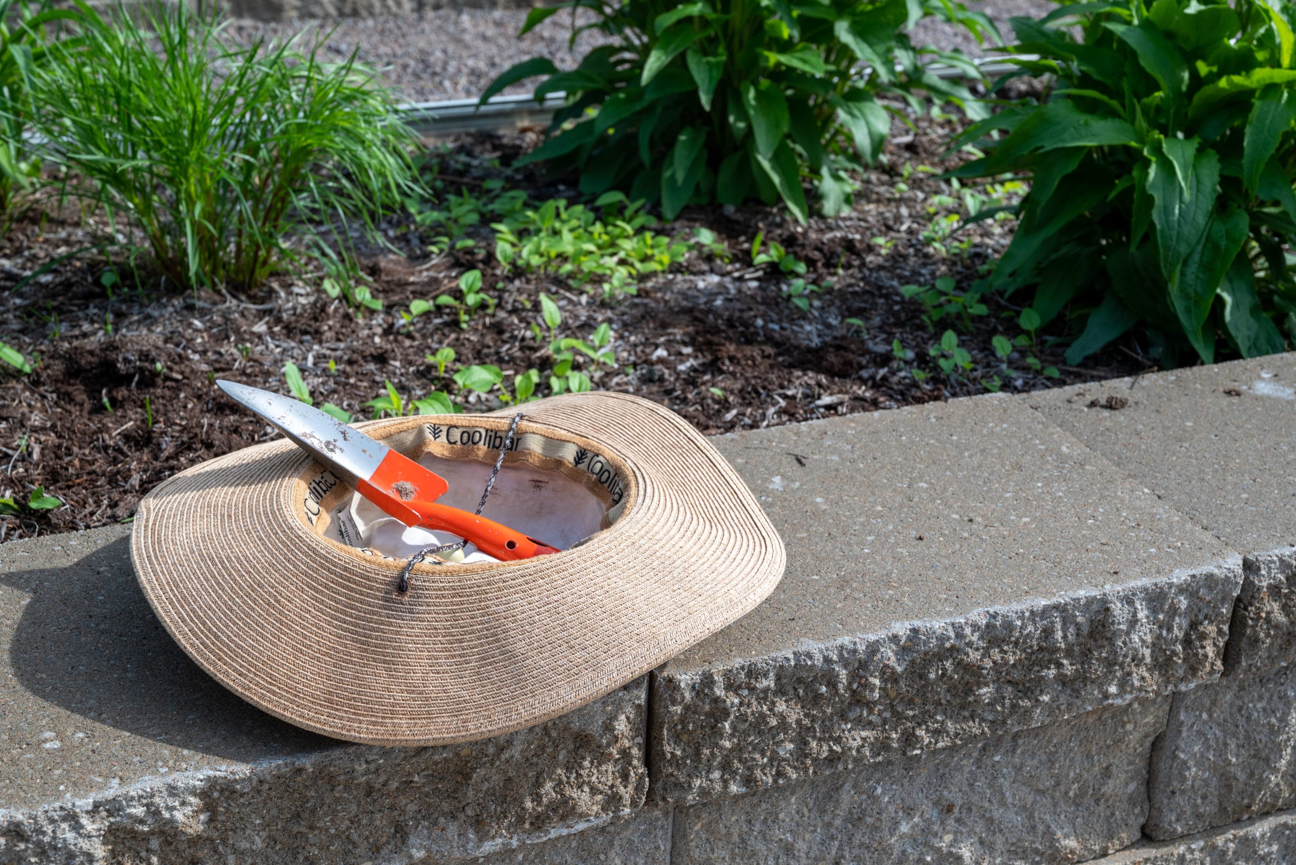 A gardening hat and spade rest on the paver stones at the GHV embankment